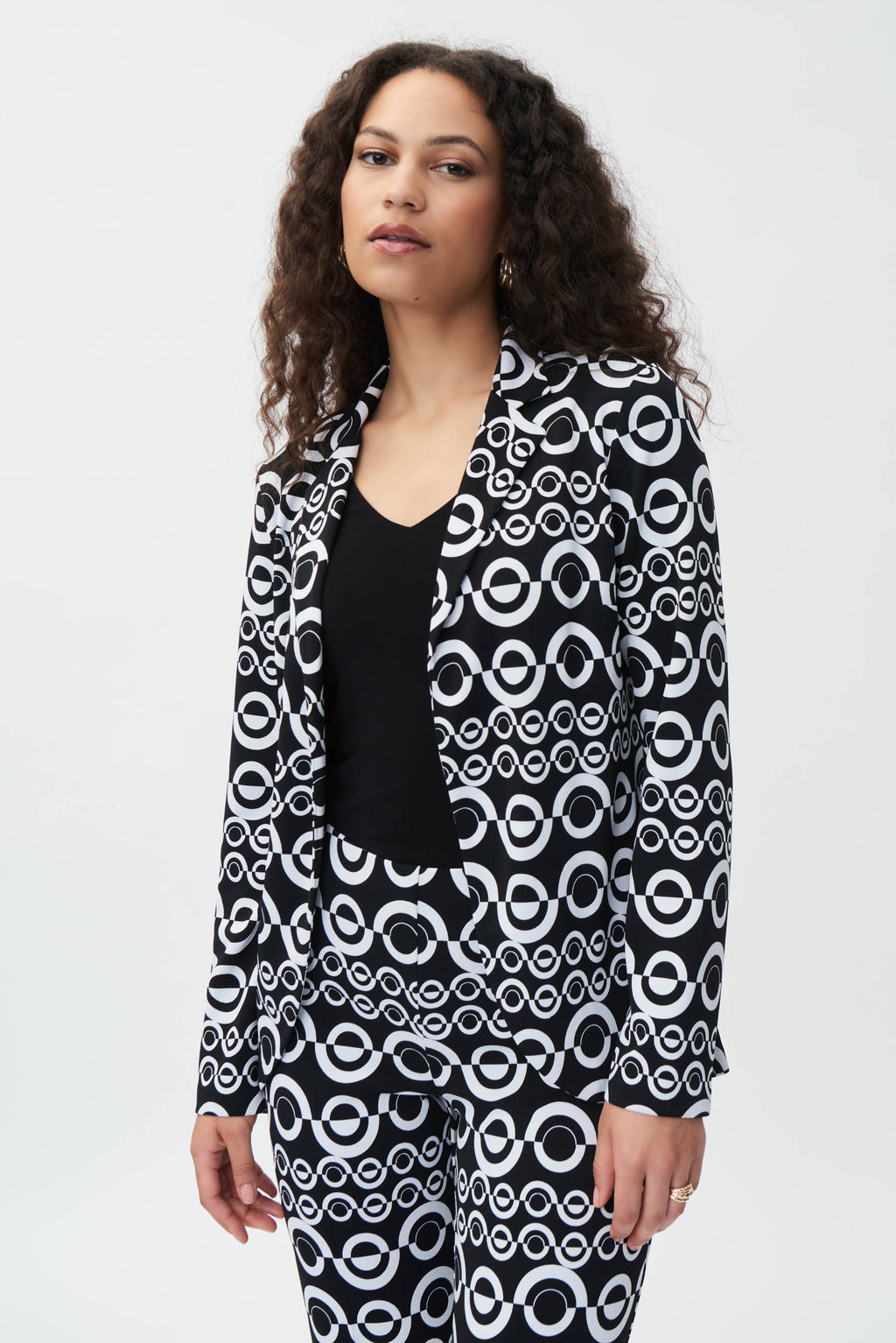 Striking a balance between relaxed and cosmopolitan, this geometric print blazer features a shawl collar and a flared style that's guaranteed to elevate your ensemble. Cut in a comfortable silky knit material, this chic blazer is defined by a notched collar and long straight sleeves. Whether you're meeting friends for brunch or heading to the office, this blazer is sure to make a statement.