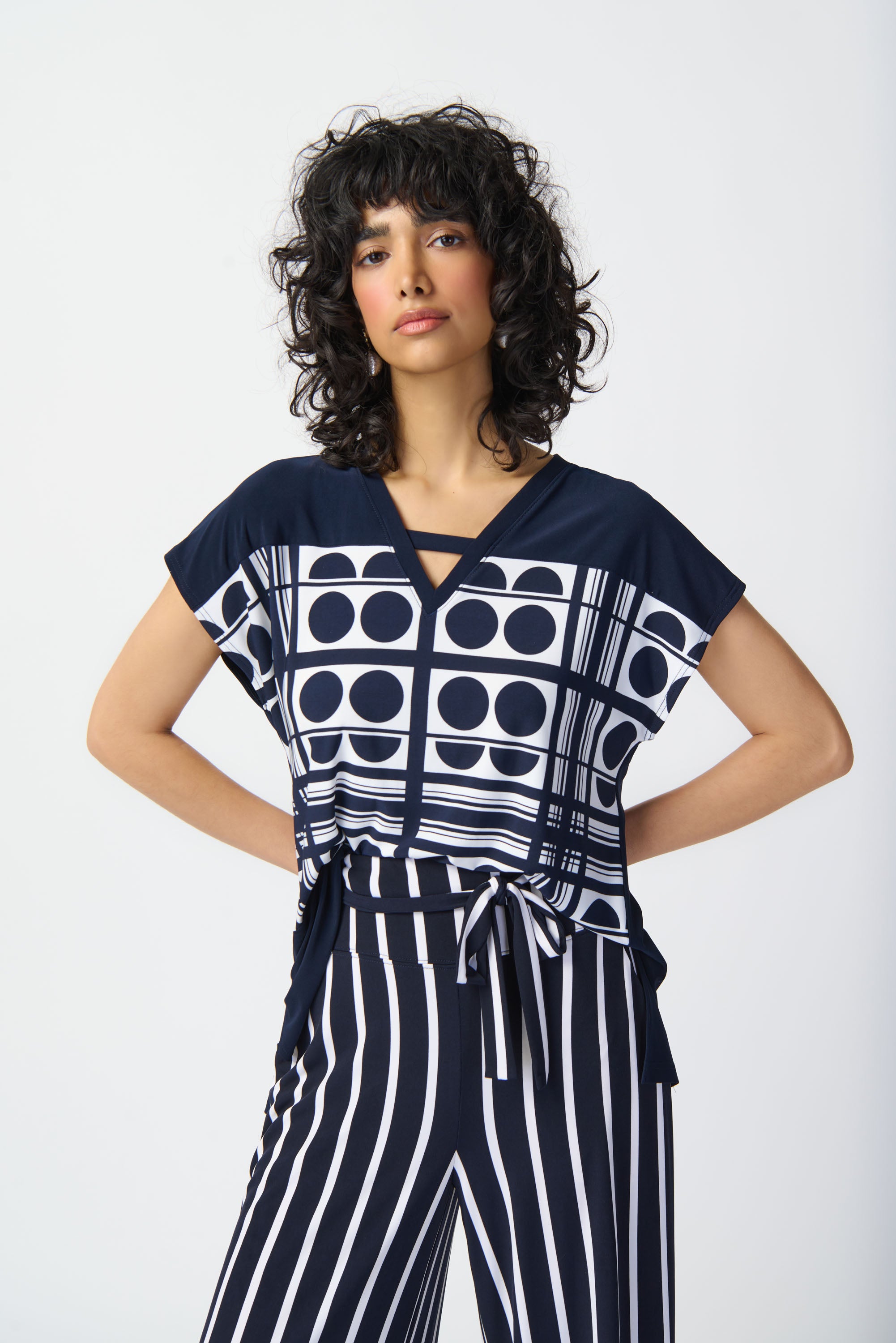 Elevate your look effortlessly with this lovely geometric printed top. The short raglan sleeves and V-shaped neckline lend a relaxed fit for everyday wear and give character to this contemporary piece. The side seam slits at the sweep add a subtle chic detail that also allows for easy movement.