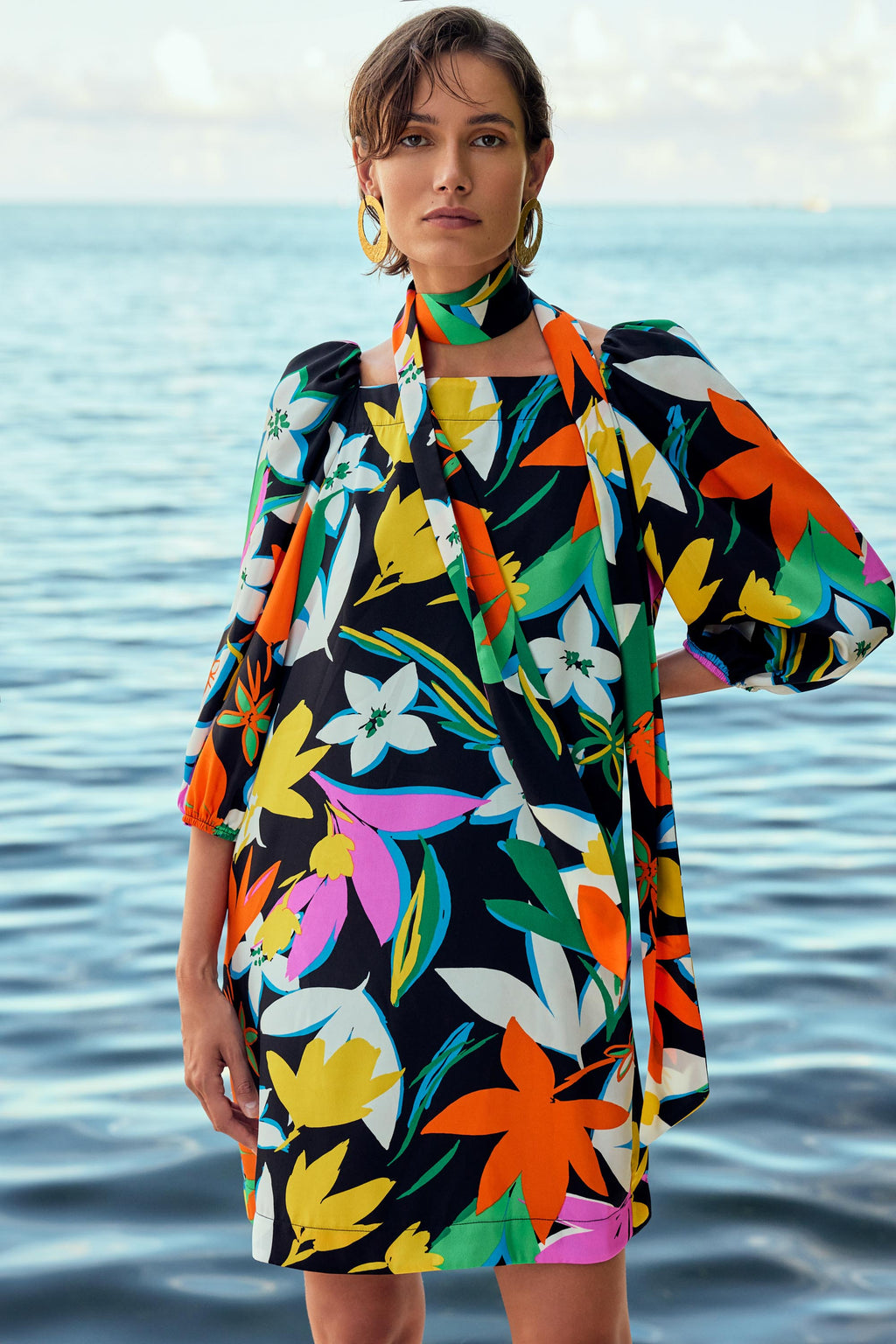 Stand out in this stunning long-sleeved satin dress featuring a colourful and vibrant floral print that exudes femininity. The chic square neckline and elegant puff sleeves complement the beautiful pattern, while the comfortable lining ensures a smooth and sophisticated fit.