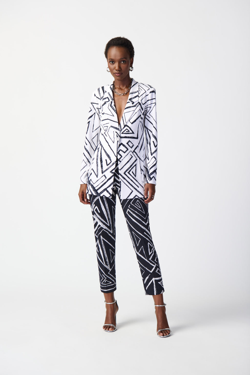 Elevate your look with this vibrant abstract print blazer. Tailored in silky knit fabric, this piece blends style and simplicity effortlessly by pairing a bold, boxy silhouette with a beautiful, notched collar.