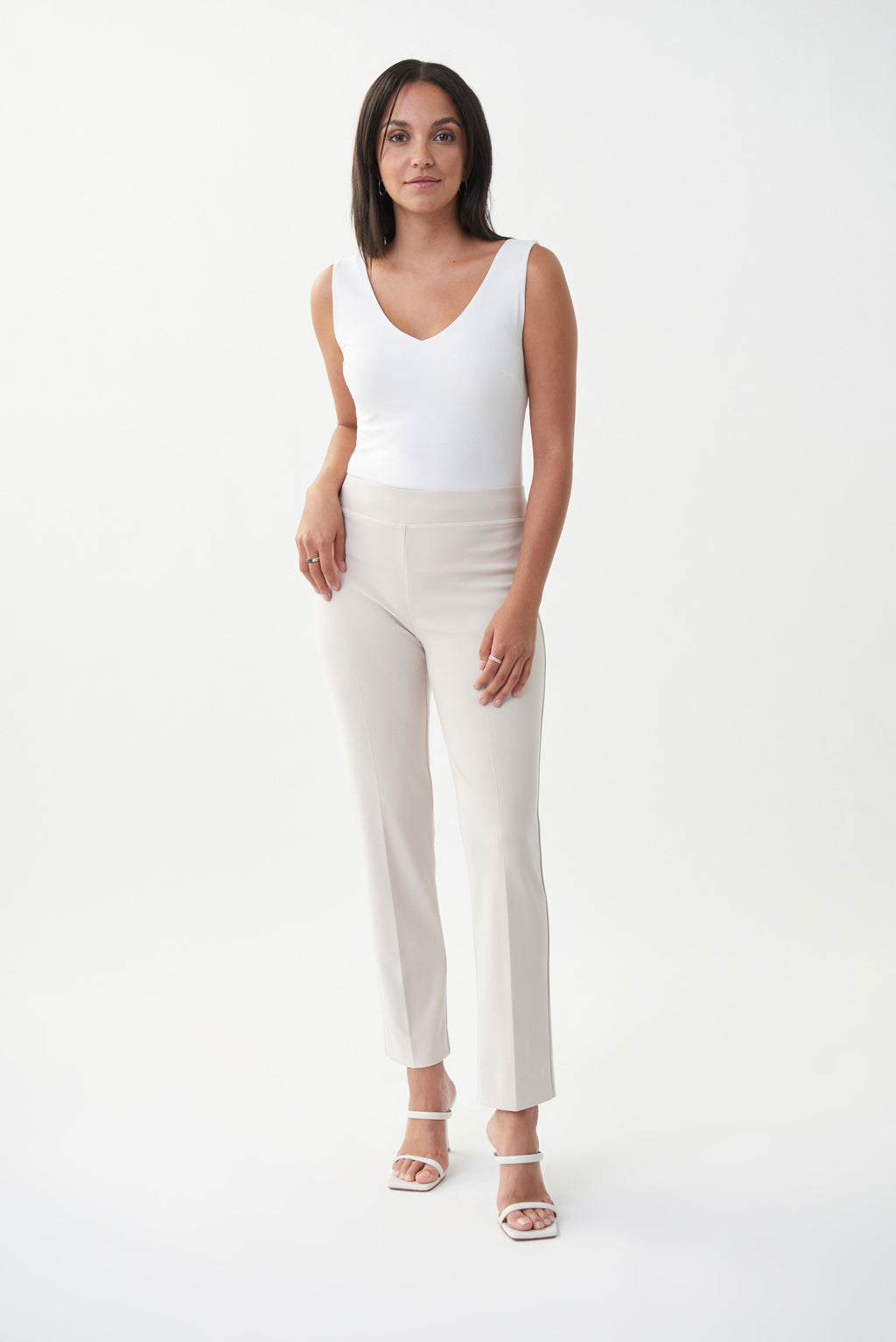 If you're a woman-on-the-go searching for the perfect everyday pants, then look no further. This sand coloured straight-fit pull-on pant is ideal for the woman who prioritizes comfort and versatility. The flattering silky knit material paired with a covered elastic waistband creates an effortless style, while the slits on the back bottom legs give a classy detail.