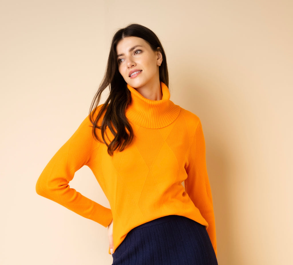 Stay Cozy and Chic with our Super Soft Viscose Mix Relaxed Fit Orange Diamond Pattern Sweater. Experience Unmatched Comfort and Style with Ribbed Cuff, Hem, and a Detachable Snood. Stay Warm and Fashionable this Season 