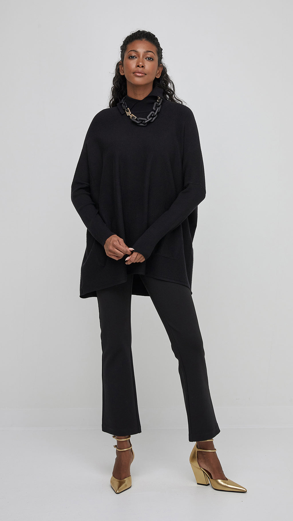 The oversized silhouette of this jumper not only adds a contemporary flair but also ensures a comfortable and flattering fit for all body types. Its versatile black color makes it easy to pair with various bottoms, from jeans to skirts, allowing for endless styling possibilities.