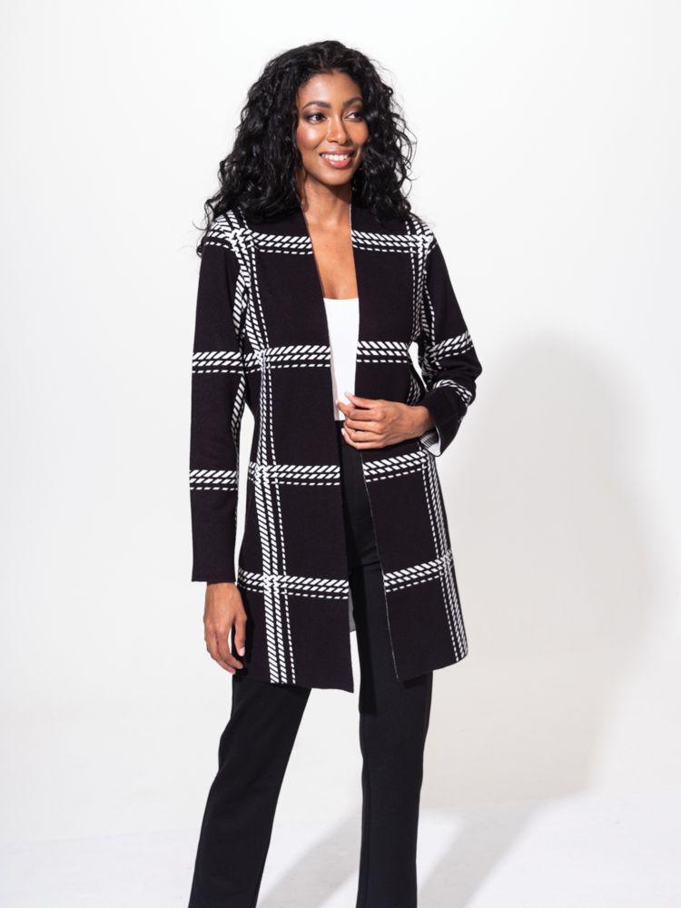 Elevate  your cozy style with this long line Alison Sheri cardigan!  It features two convenient patch pockets on the front, perfect for storing your essentials or keeping your hands warm. The soft touch fabric adds a luxurious feel to this black and cream cardigan. With its edge-to-edge design, it effortlessly drapes over your outfit for a chic and effortless look. Stay comfortable and fashionable with this must-have cardigan! 