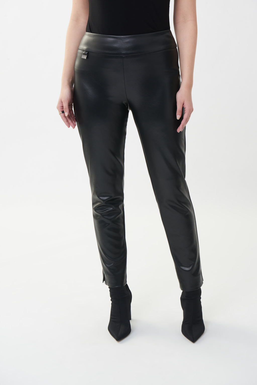 Joseph Ribkoff solid leatherette trousers are slim fit pull on trousers with a structured contour waistband and a beautiful Joseph Ribkoff tab ornament.