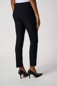 These black Joseph Ribkoff slim-fit pull-on trouser, constructed in a woven Millennium fabric, provide just the right amount of weight and stretch for a form-flattering fit. Also feature a structured contour waistband and a subtle JR tab ornament on the front so you can feel comfortable and confident wherever the day takes you.